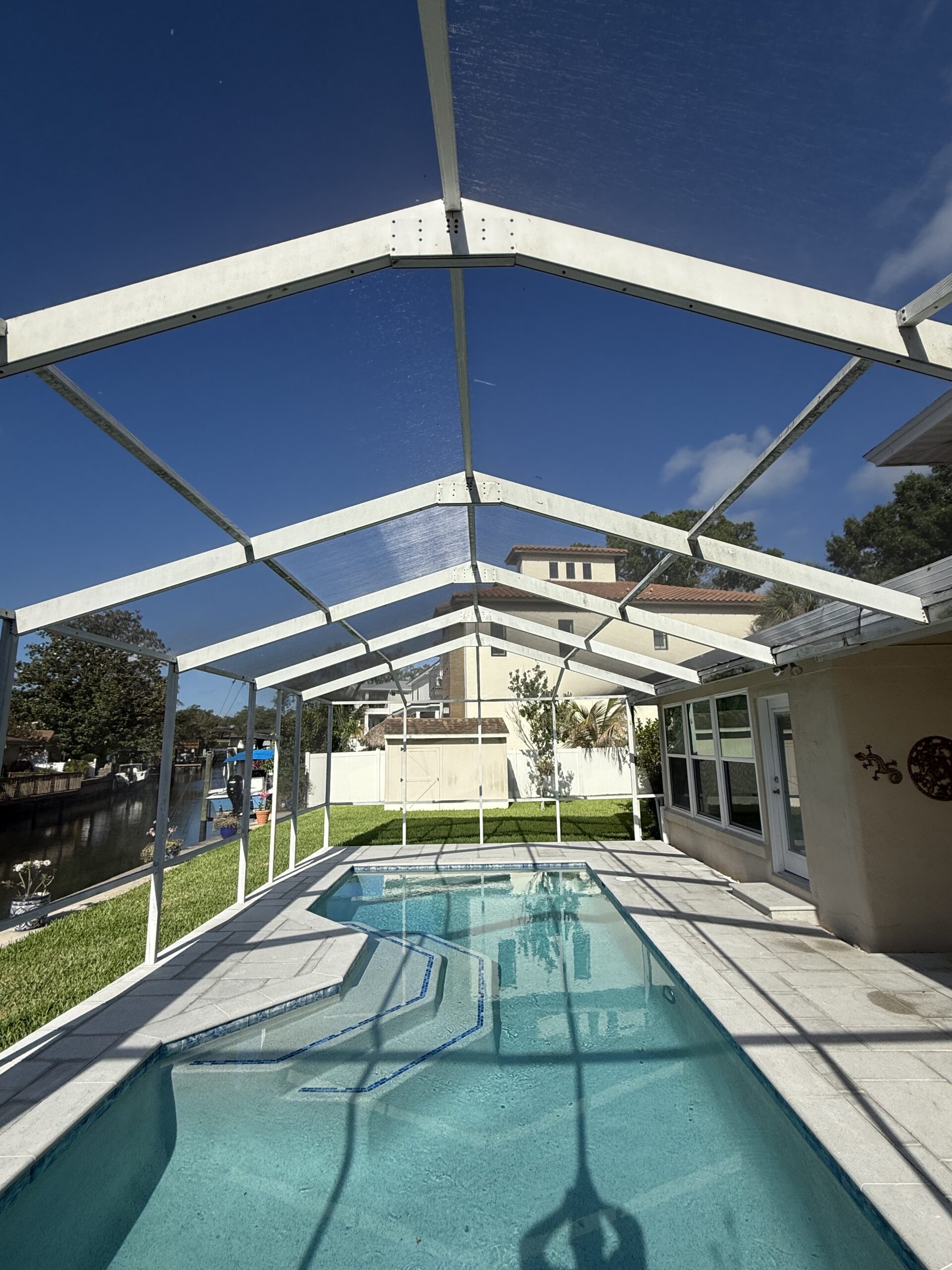 White aluminum pool cage before painting in Tampa Florida