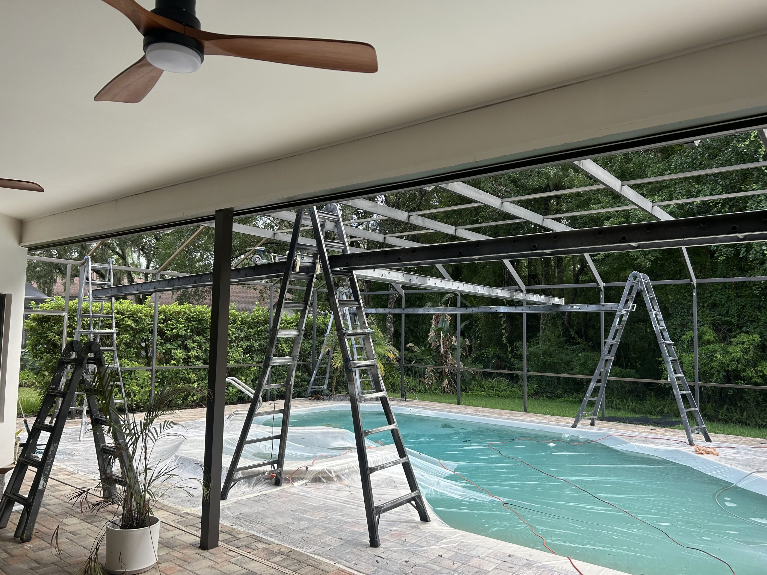 Pool cage before painting and restoration in Tampa Palms Tampa Florida