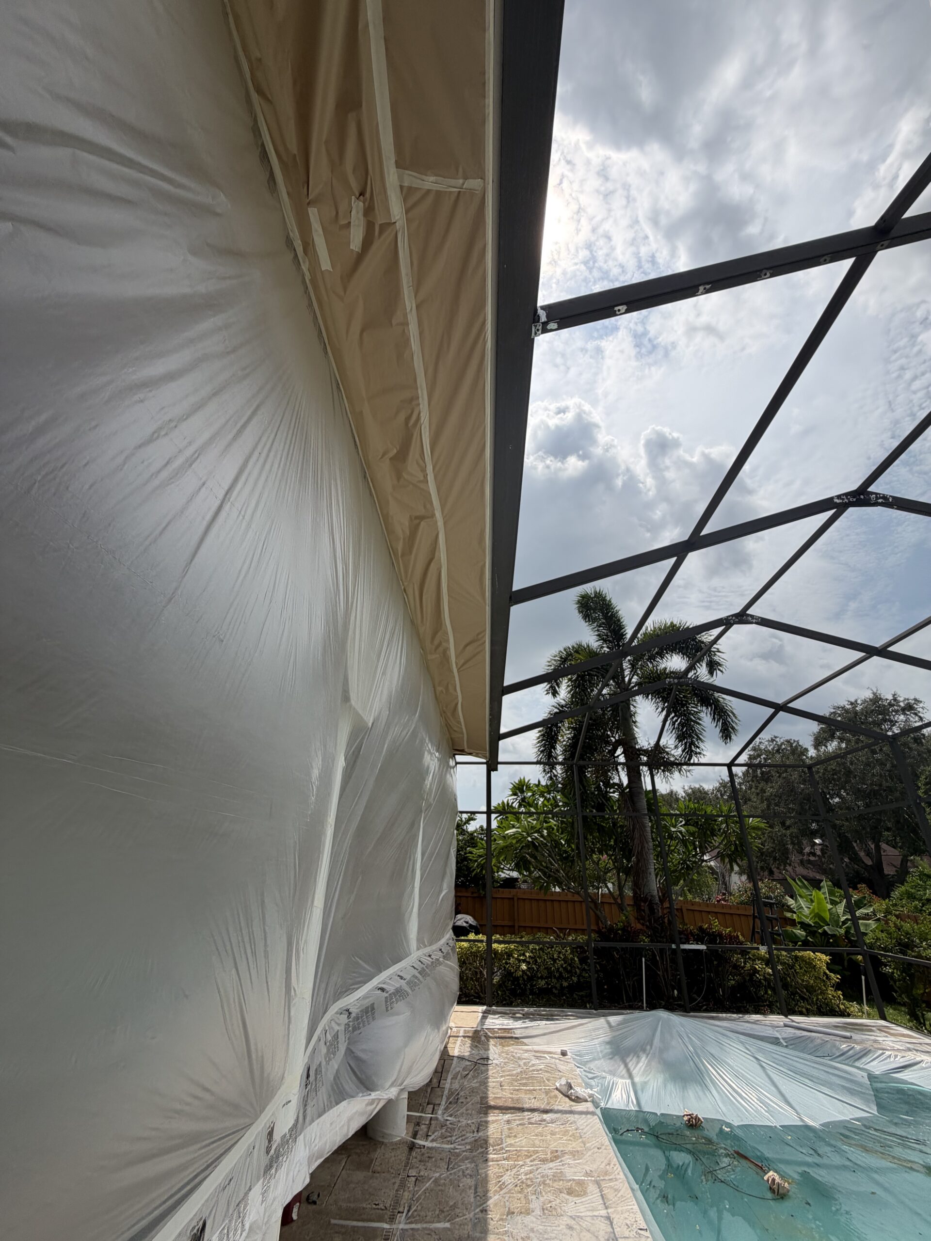 Older oxidized pool cage during restoration preparation in Carrollwood Tampa Florida