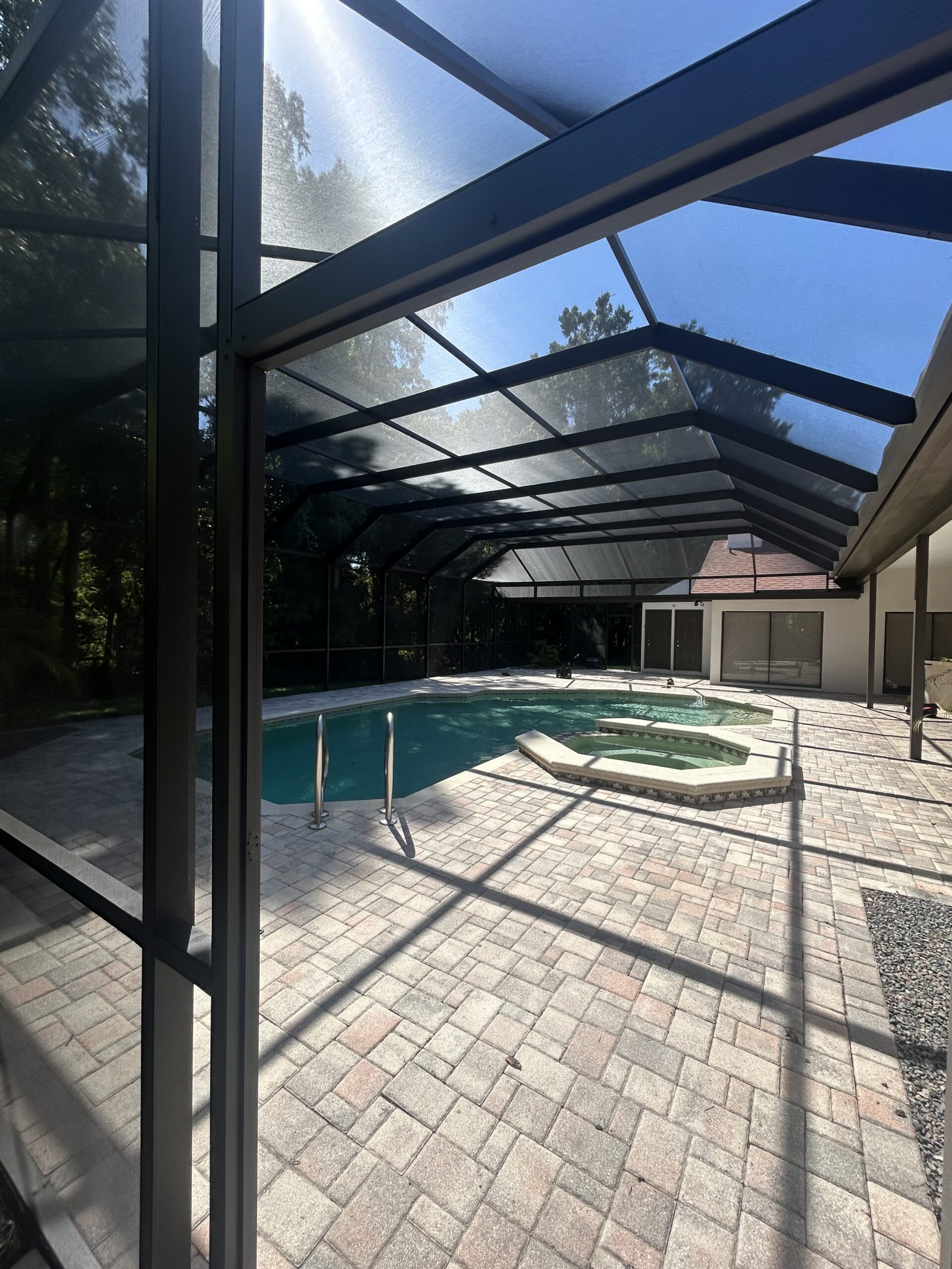 Finished dark bronze pool cage painting and rescreening in Tampa Palms Tampa Florida